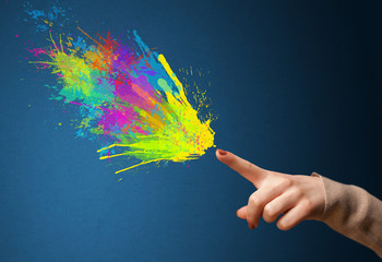 Colorful splashes are coming out of gun shaped hands