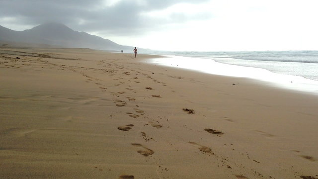 Man jogging on the Cofete beach, Fuerteventura - front view