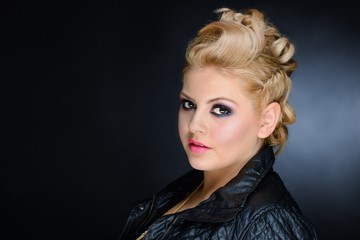 Young blonde woman with make-up and black leather jacket