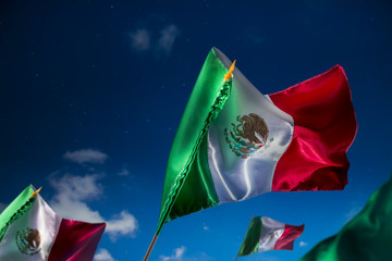 Mexican flags against a night sky, independence day, cinco de ma