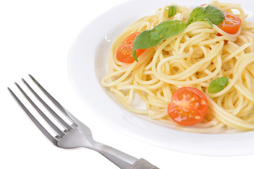 Delicious spaghetti with tomatoes on plate close-up