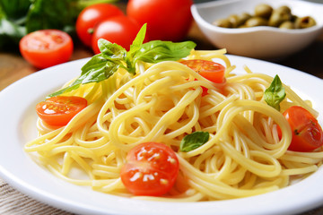 Delicious spaghetti with tomatoes on plate on table close-up © Africa Studio