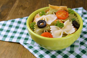 Delicious pasta with tomatoes on plate on table close-up