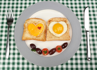 Scrambled eggs with bread on plate, on color napkin