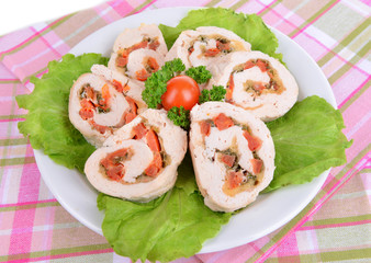 Delicious chicken roll on plate on table close-up