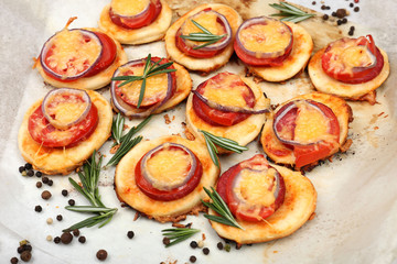 Small pizzas on baking paper close up