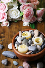 Fototapeta na wymiar Composition with spa stones, candles and flowers