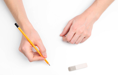 Human hands with pencil and erase rubber, isolated on white