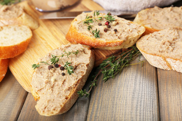 Fresh pate with bread on wooden table