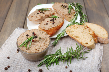 Fresh pate with bread on wooden table