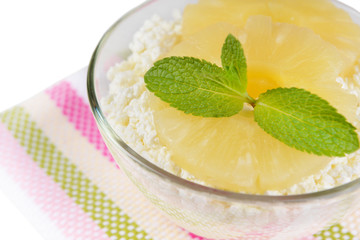 Bowl of tasty cottage cheese with pineapple, close up