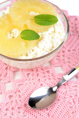 Bowl of tasty cottage cheese with pineapple, close up