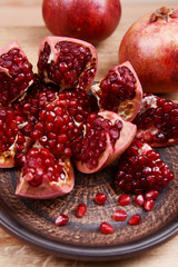 Ripe pomegranates on table close-up