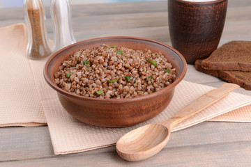 Boiled buckwheat in bowl on table close-up