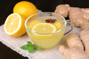 Obraz na płótnie Canvas Healthy ginger tea with lemon and honey on table close-up