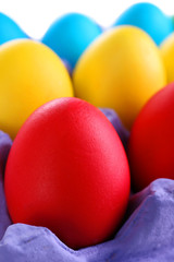 Colorful Easter eggs in tray close up