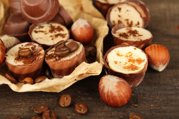 Obraz na płótnie Canvas Tasty chocolate candies with coffee beans and nuts