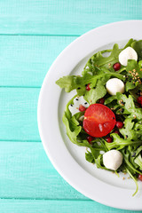 Green salad made with  arugula, tomatoes, cheese mozzarella