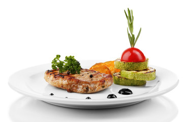 Grilled steak and grilled vegetables on plate, isolated on