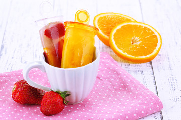 Fruit ice cream in cup on wooden table close-up
