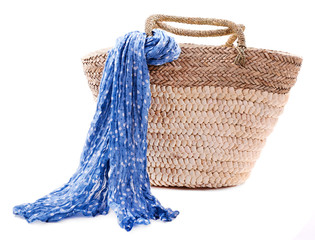 Obraz premium Wicker bag with colorful scarf, isolated on white