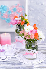 Beautiful bouquet of bright flowers in jars