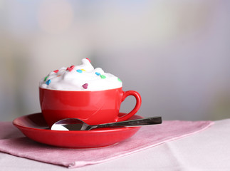 Cup of strong coffee with cream and candies