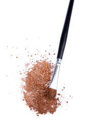 Crushed eyeshadow and professional make-up brush isolated