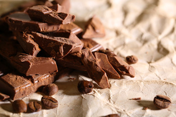 Chopped bar of chocolate on light background