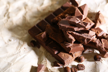 Chopped bar of chocolate on light background