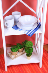 Beautiful white shelves with tableware and decor