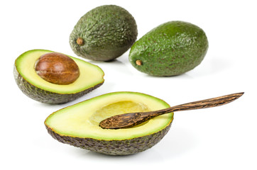 Fresh avocado with wooden spoon isolated