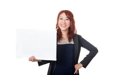 Asian office girl stand with arms akimbo and a blank sign