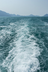 View of waves in turquoise water behind a boat