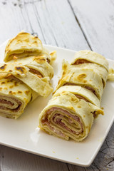 Roll of piadina with ham and cheese