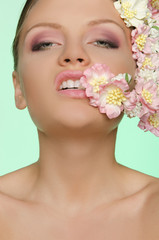 Fototapeta premium Beautiful woman bites flower