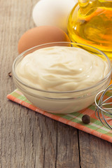 mayonnaise sauce in bowl on wood