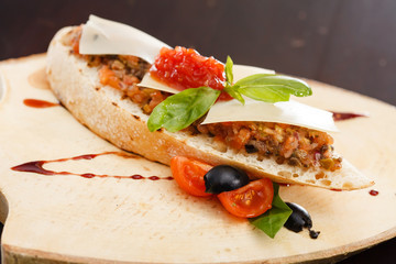 Italian appetizer bruschetta with tomato, basil and black olives