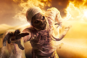 Scary mummy in a desert at sunset - obrazy, fototapety, plakaty