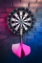 Obraz premium Dart about to hit target with dramatic lighting