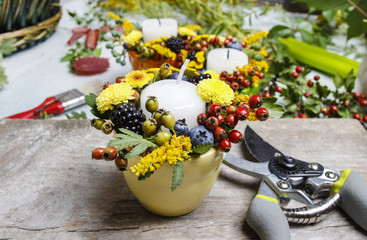 Florist at work. Woman making autumn floral decorations