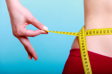 Diet. woman fit girl with measure tape measuring her waist