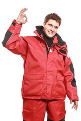 Young man sailor in red wind jacket. Sailing.