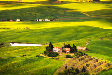 Pienza, rural sunset landscape. Countryside farm and green field