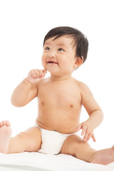 smiling Infant child baby sitting and look up