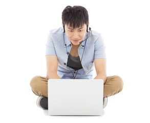 Young man sitting on floor and using a laptop