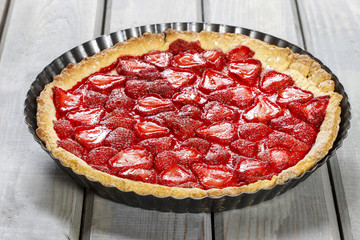 Strawberry tart isolated on wooden table