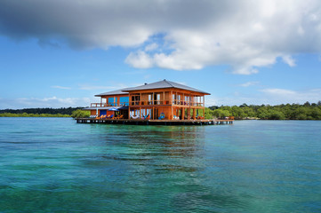 House on stilts over water of the Caribbean sea