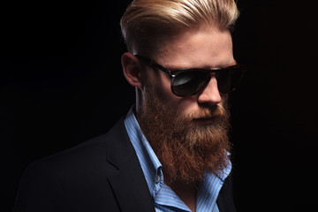 bearded business man looks down