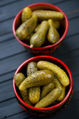 Gherkins in wooden bowls, high angle view, vertical shot